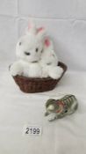 A tin plate clockwork cat (no key) and a musical rabbits in basket.