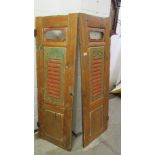 A pair of painted wooden shutters.