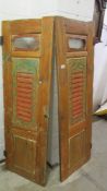 A pair of painted wooden shutters.