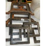 A quantity of old cast iron printing iron frames.