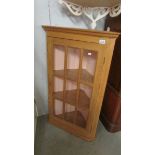 A pine corner cabinet.