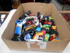 A box of mixed playworn diecast and plastic vehicles