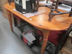 An oval solid pine kitchen table 90cm x 151cm x height 76cm