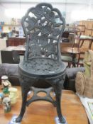 A garden chair in the style of a cast iron one (possibly made from hard plastic)