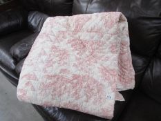 A large quilted cotton bed cover in soft pink and cream floral pattern 230cm x 230cm