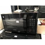 A black Samsung smart oven microwave