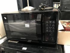 A black Samsung smart oven microwave