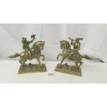 A pair of brass Noblemen on horses.