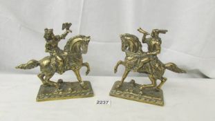 A pair of brass Noblemen on horses.
