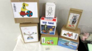Eight boxed tin plate toys including Robots, motor cycle, rower, dogs.