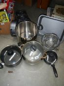 A mixed lot of stainless steel pans etc.