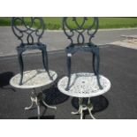 2 circular garden tables and 2 chairs.