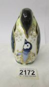 A Royal Crown Derby penguin with baby, gold stopper, in good condition.