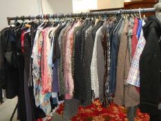 A rail of assorted clothing including coats, jackets, shirts etc., (some vintage).