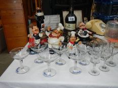 A quantity of Babycham glasses, alcohol related figures etc.