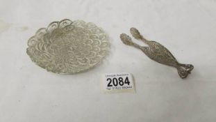 A silver filigree dish and a pair of filigree sugar tongs.