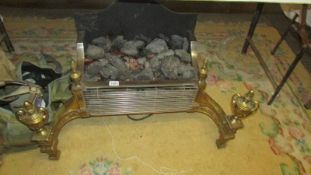 A heavy brass and metal coal effect fire.