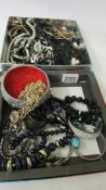 Two boxes of assorted costume jewellery.
