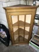 A pine corner cabinet.