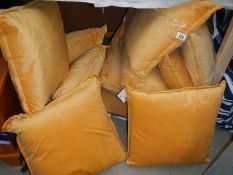 A quantity of gold coloured cushions.