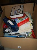 A box of assorted stationery items.