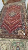 An old red patterned rug, a/f (has hole, see images). 155 x 250 cm.