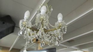 A 6 lamp glass chandelier.