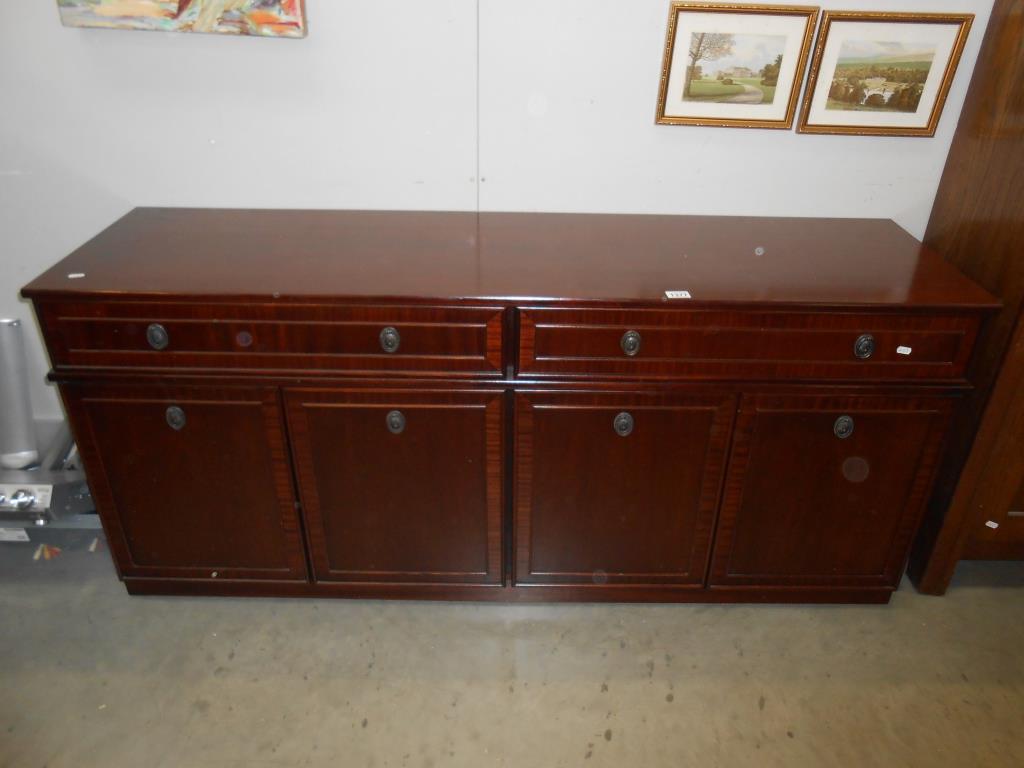 A dark wood stained sideboard with 2 drawers and 4 doors, 1 drawer being a cutlery drawer,