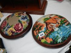 Two circular foot stools with embroidered tops.