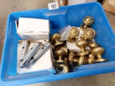 A box of brass knobs, hinges & catches etc.