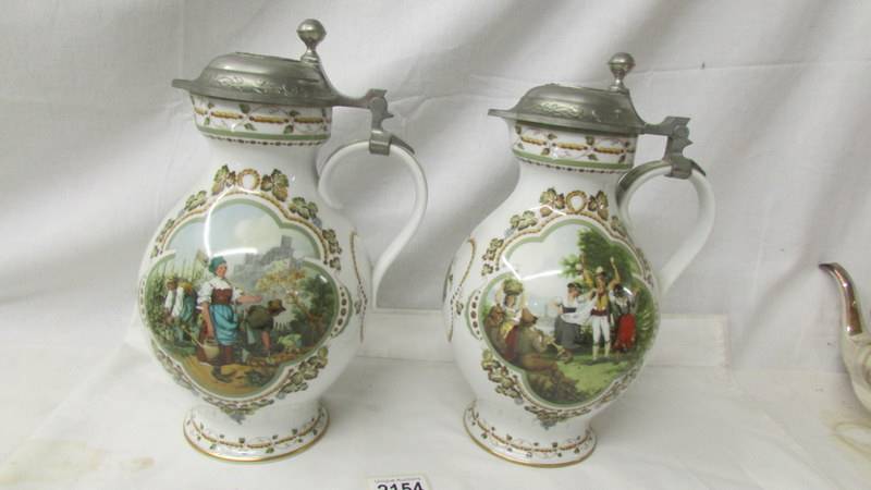 A superb quality pair of German porcelain beer jugs with metal lids designed by Rupert Schneider.