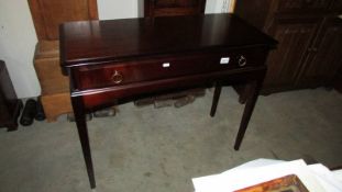 A mahogany single drawer side table.