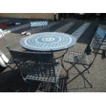 A metal garden table and chairs with tiled top.