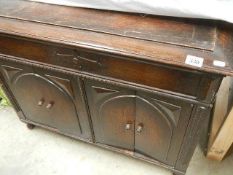 An old oak box with two doors in front.