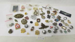 A mixed lot of badges including military.
