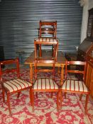 A set of 4 brass inlaid dining chairs with regency pattern seats.