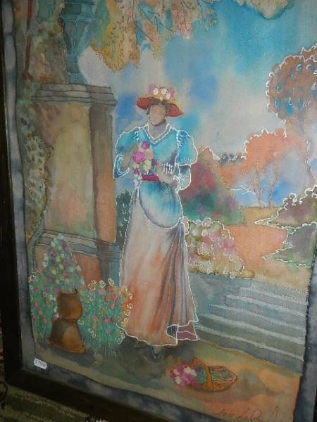 A framed and glazed picture of a lady with no face in a garden. - Image 2 of 2