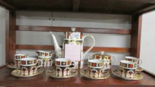 A Royal Crown Derby 15 piece coffee set (coffee pot a/f, handle cracked).