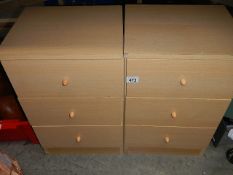 A pair of pine effect bedside chests.