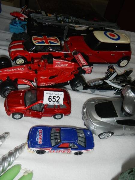 A quantity of toy racing cars etc.