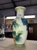 An oriental vase decorated with storks