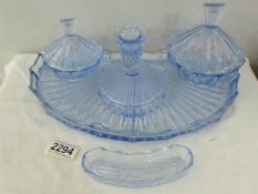 A blue glass trinket set with tray.