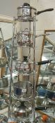 A saucepan stand and a good lot of stainless steel saucepans.
