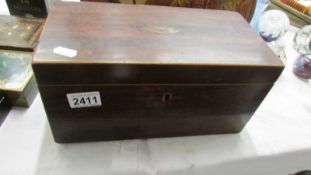 A Victorian mahogany tea caddy (missing one internal lid and mixing bowl.).