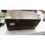 A Victorian mahogany tea caddy (missing one internal lid and mixing bowl.).