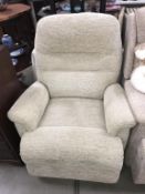 A light green/cream reclining armchair