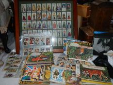 A mixed lot of assorted tea cards, framed, in albums and loose.