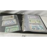 An album of foreign bank notes including Falkland Islands, India, China, St.