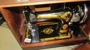 A leather cased Singer sewing machine.