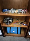 A quantity of dog items including metal stake, dog bowls,